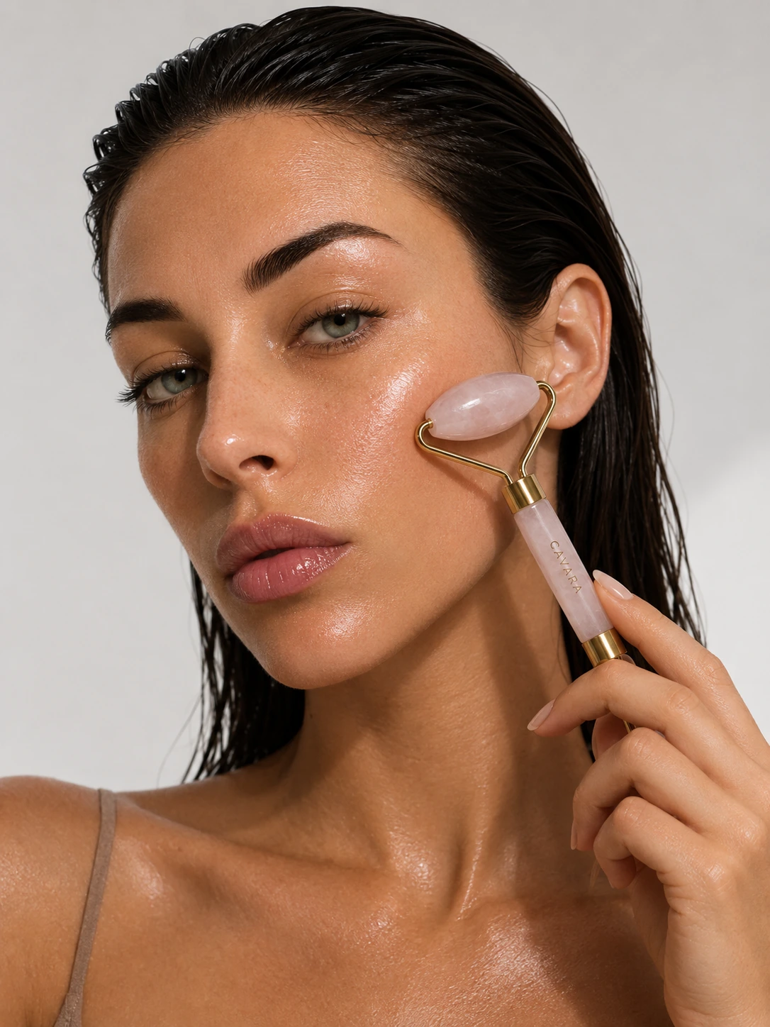 Model using the Cavara Rose Quartz Face Roller
