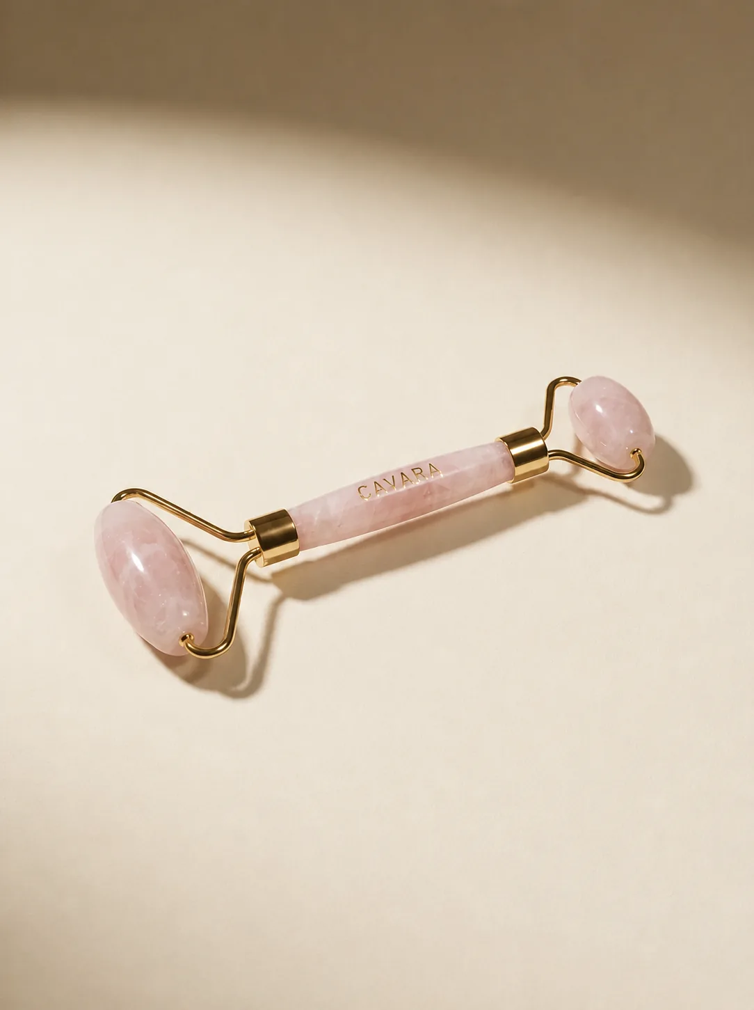 Rose Quartz Face Roller on peach